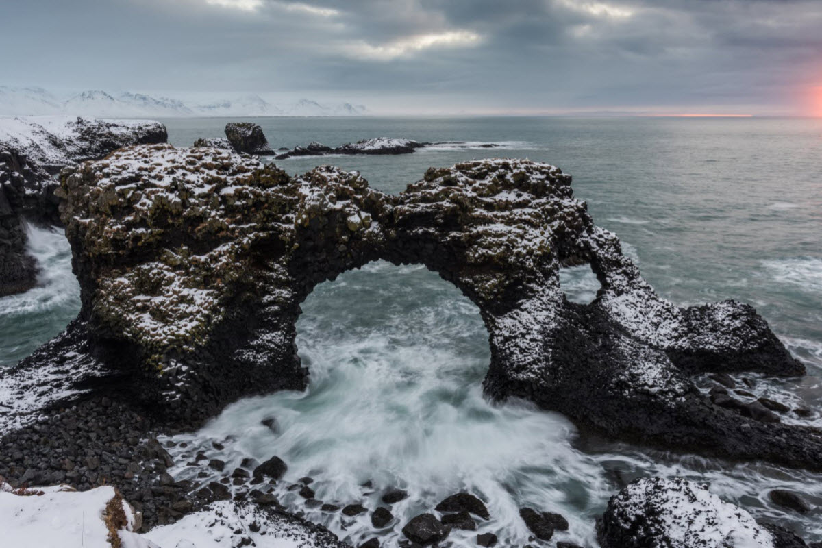 The beautiful basalt formation at Arnarstapi called Gatklettur during winter