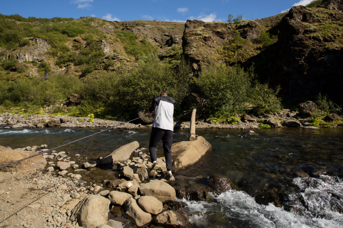 Crossing the river on the way to Glymur Waterfall during the summer in Iceland