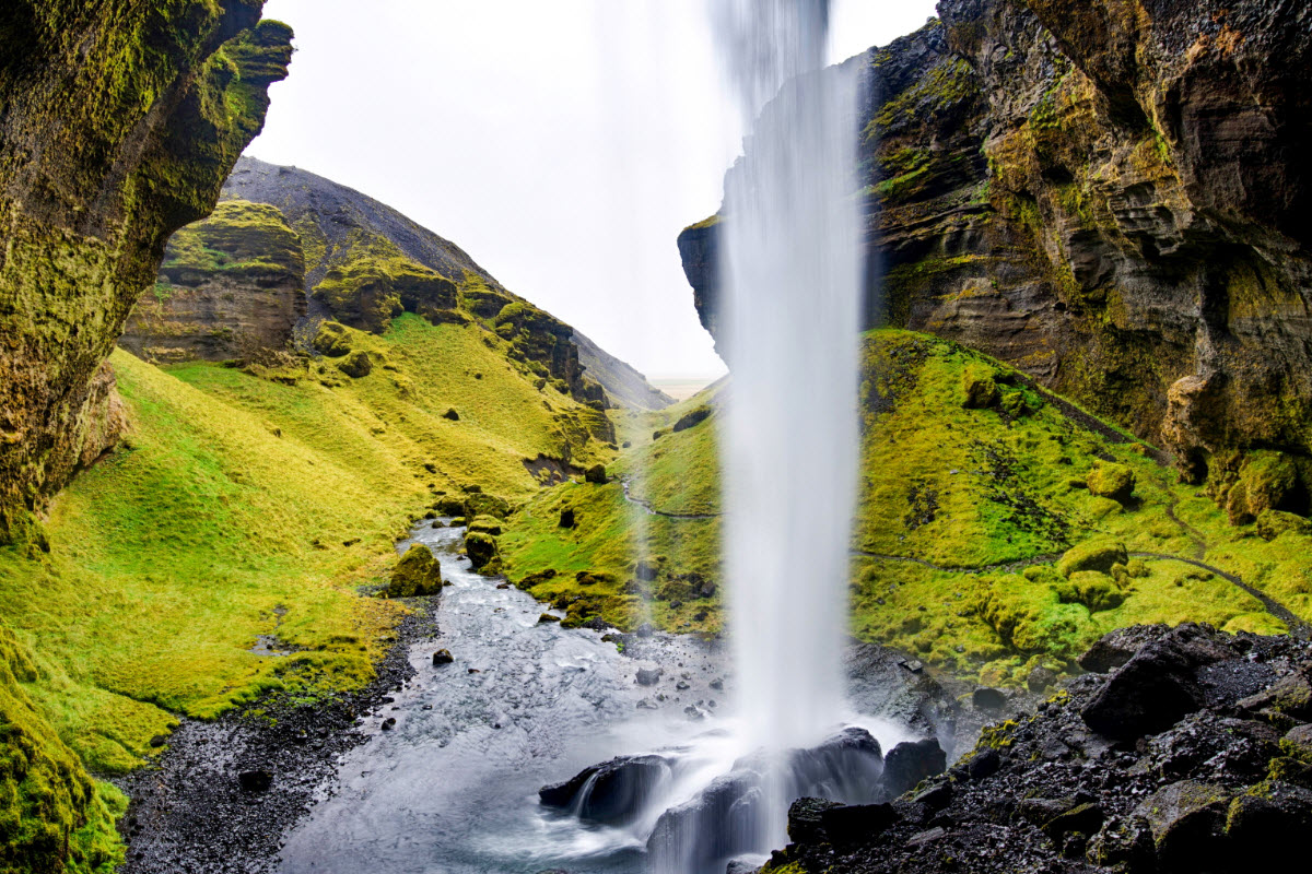 It is possible to hike behind Kvernufoss waterfall