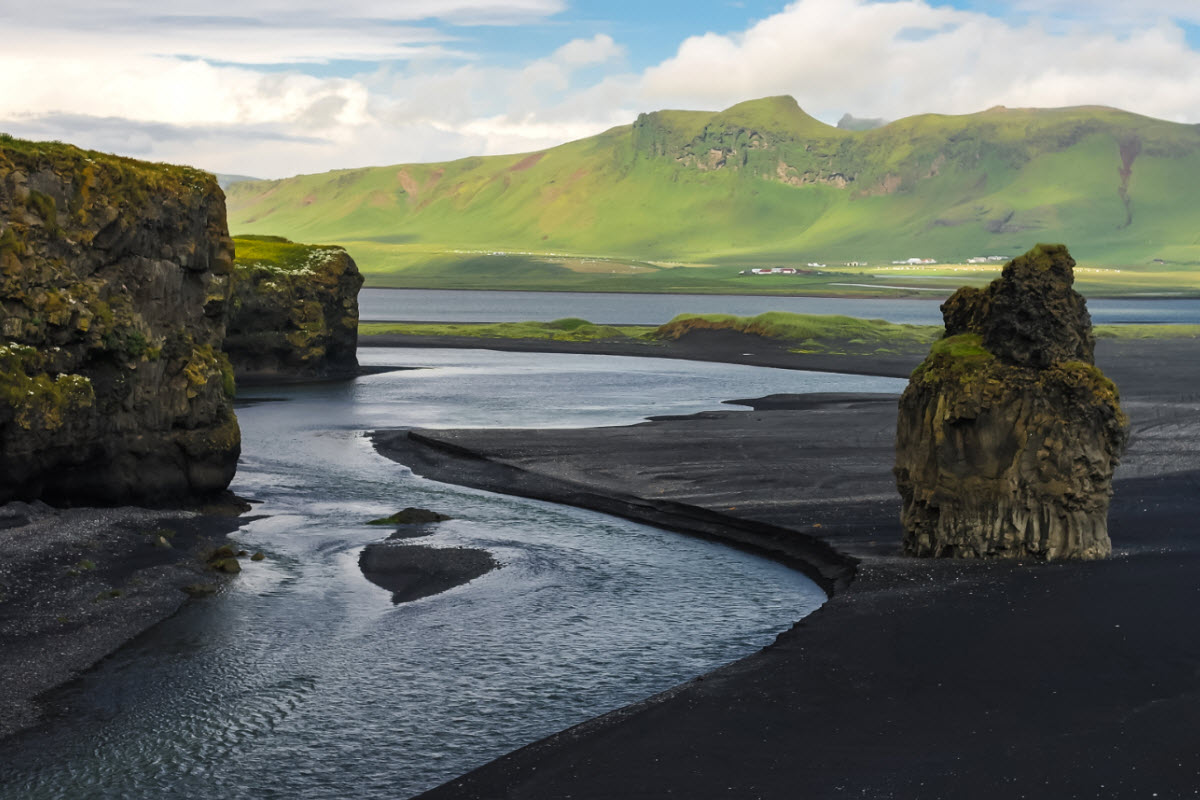 The landscape from Dyrholey cape over the black volcanic beach in South Iceland