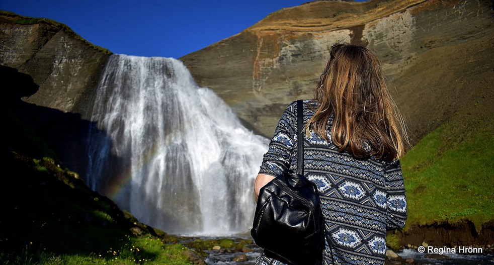 Woman looking at a waterfall