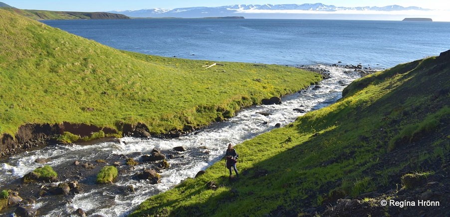 Woman next to the river and the sea